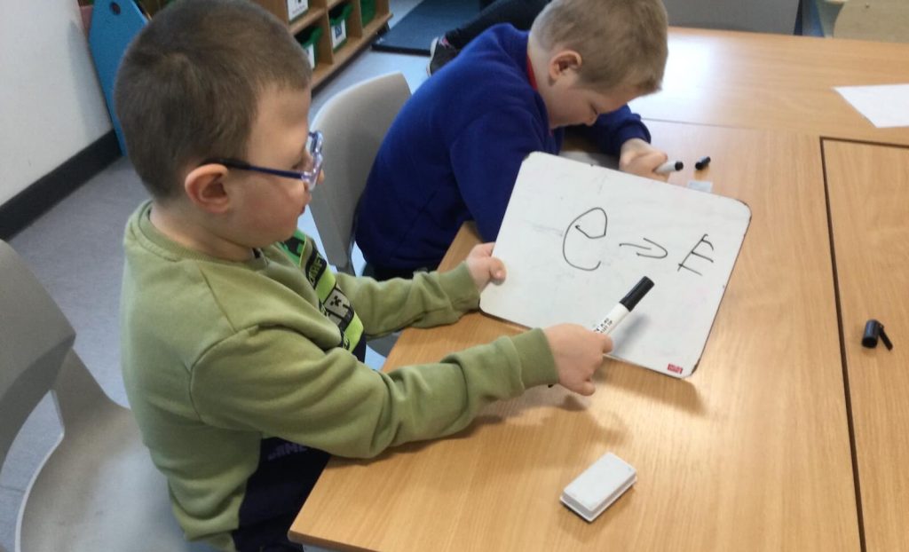 boy with writing aid