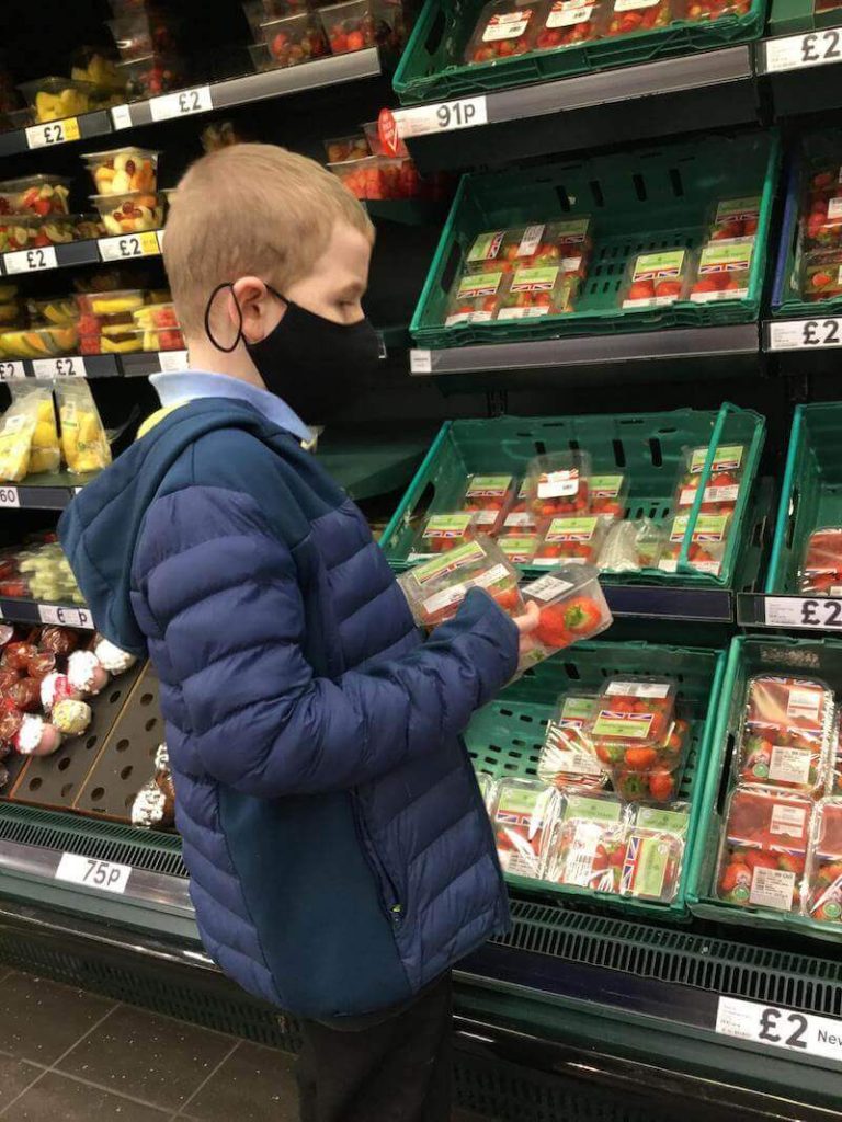student buying strawberries