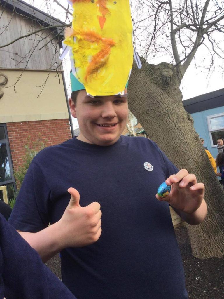 student in chick easter hat