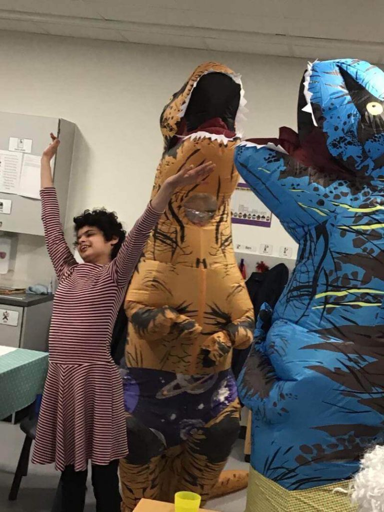 student with dinosaurs