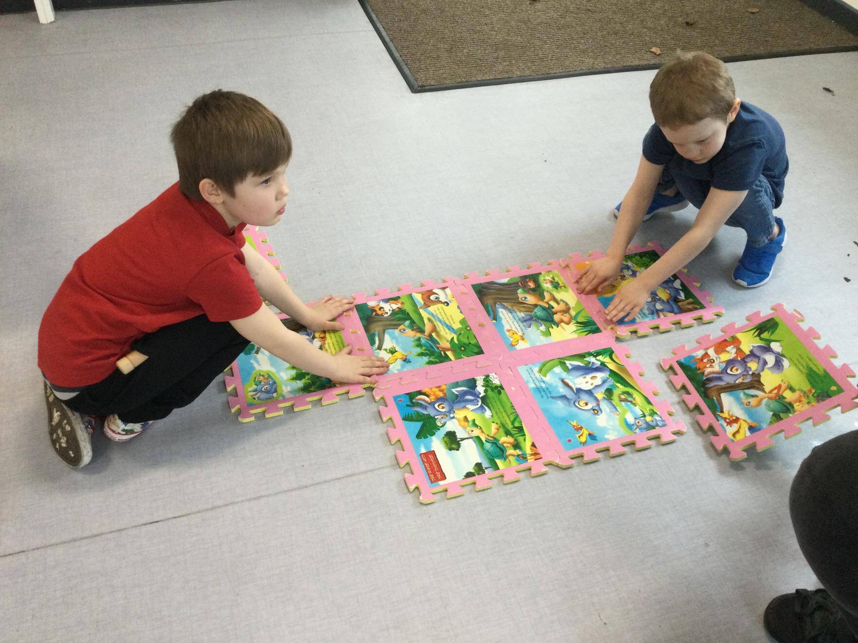 students with floor puzzle