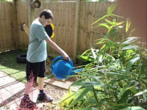 student watering plants